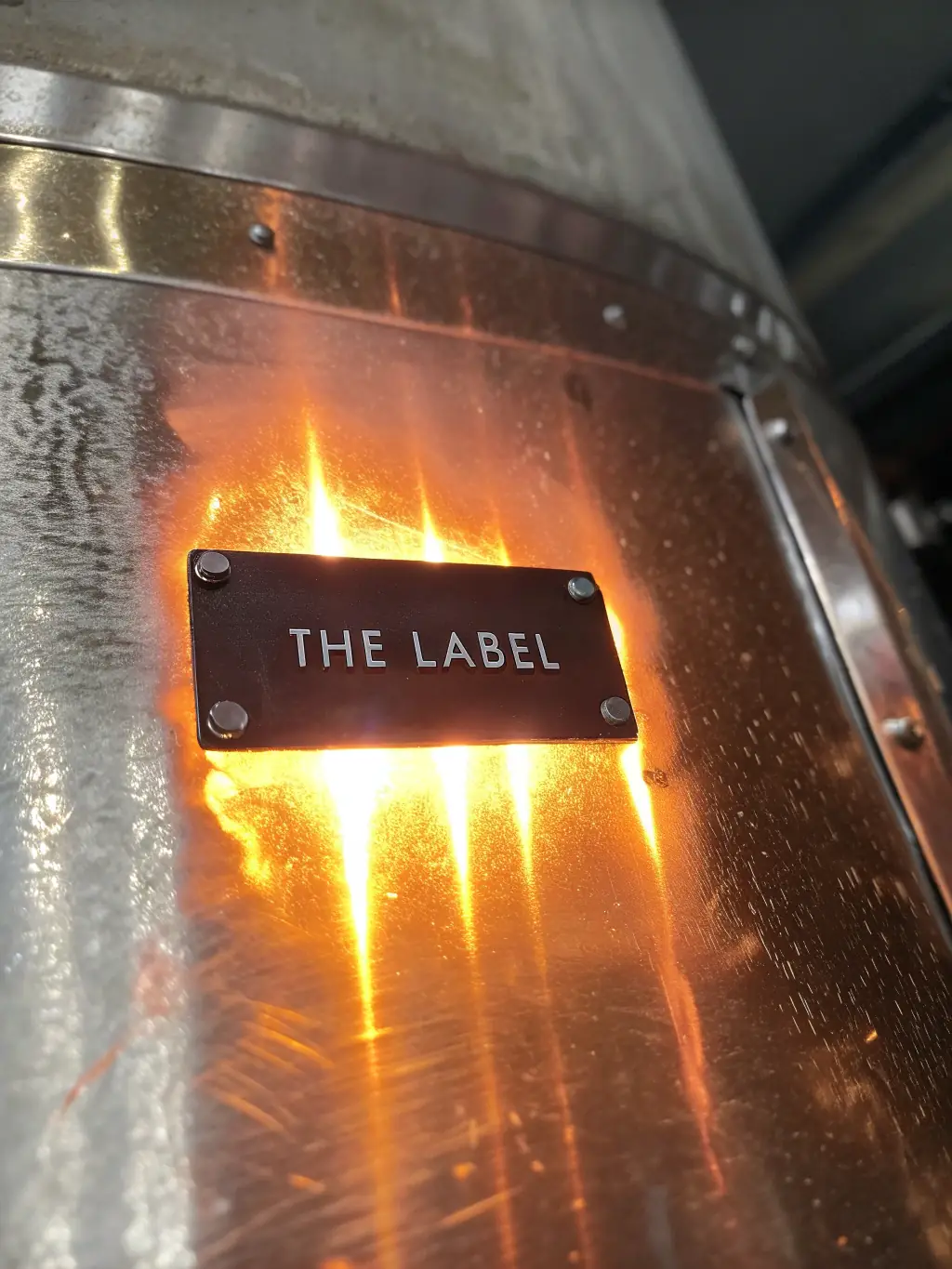 A high-temperature resistant label applied to a heated surface, showcasing its ability to maintain adhesion and legibility under extreme heat conditions.